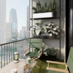 Small apartment balcony decor with cozy chair, plants, and modern shelving overlooking a city skyline.