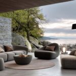 Organic modern living room with curved furniture, natural stone walls, and earthy neutral decor.