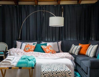 Stylish temporary home decor setup with layered bedding, cozy lighting, and removable decorative accents in a modern apartment.