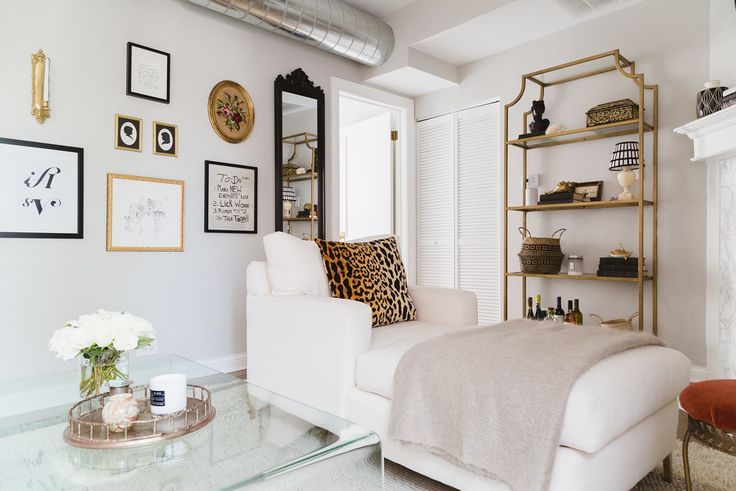 Bright temporary apartment decor with floating shelves, neutral furniture, and renter-friendly wall styling ideas.