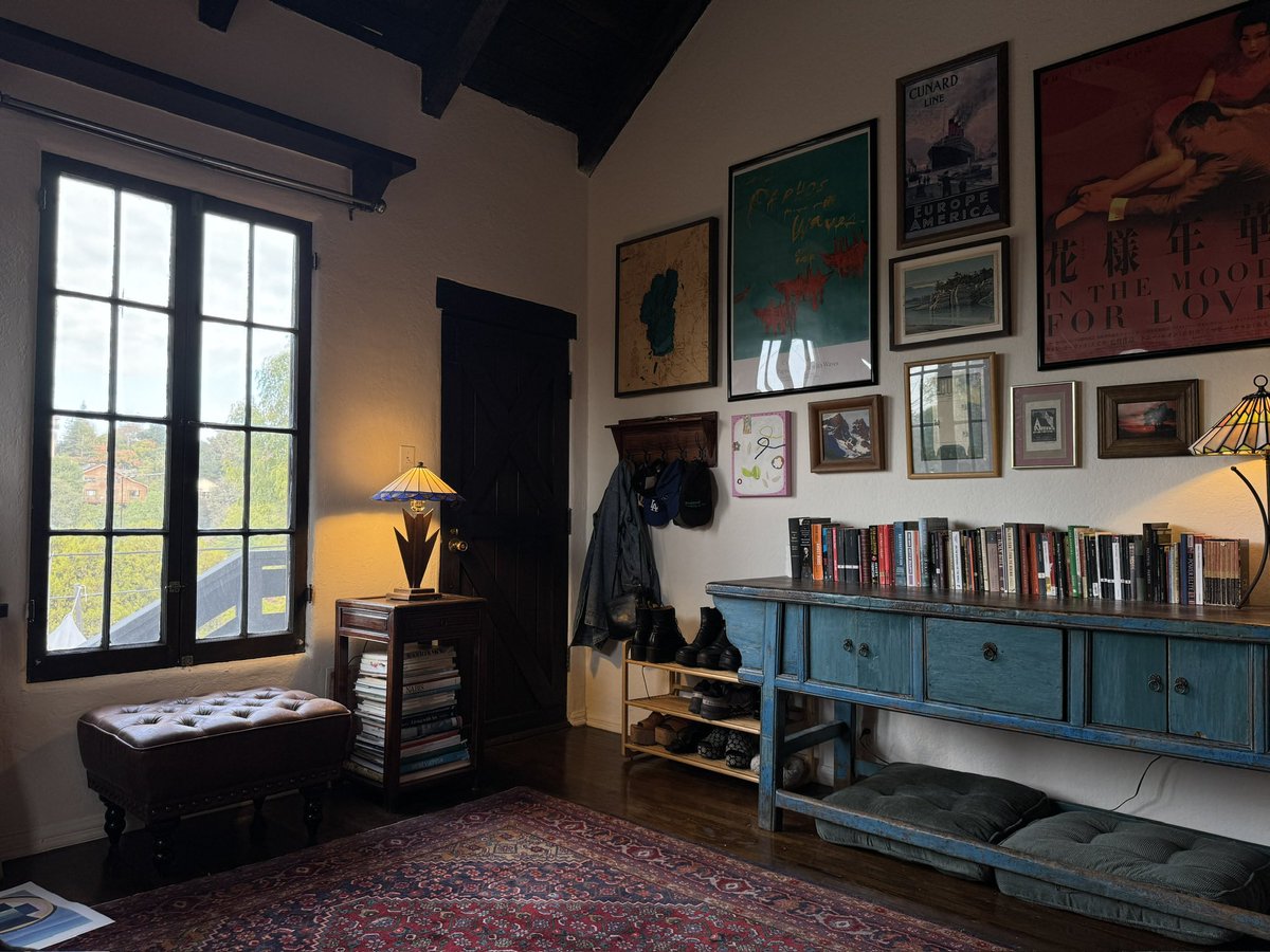 Dark vintage apartment decor with colorful artwork, classic furniture, and cozy moody interior design