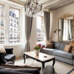 Chic Parisian apartment living room with tall windows, neutral furniture, and luxurious French interior styling.