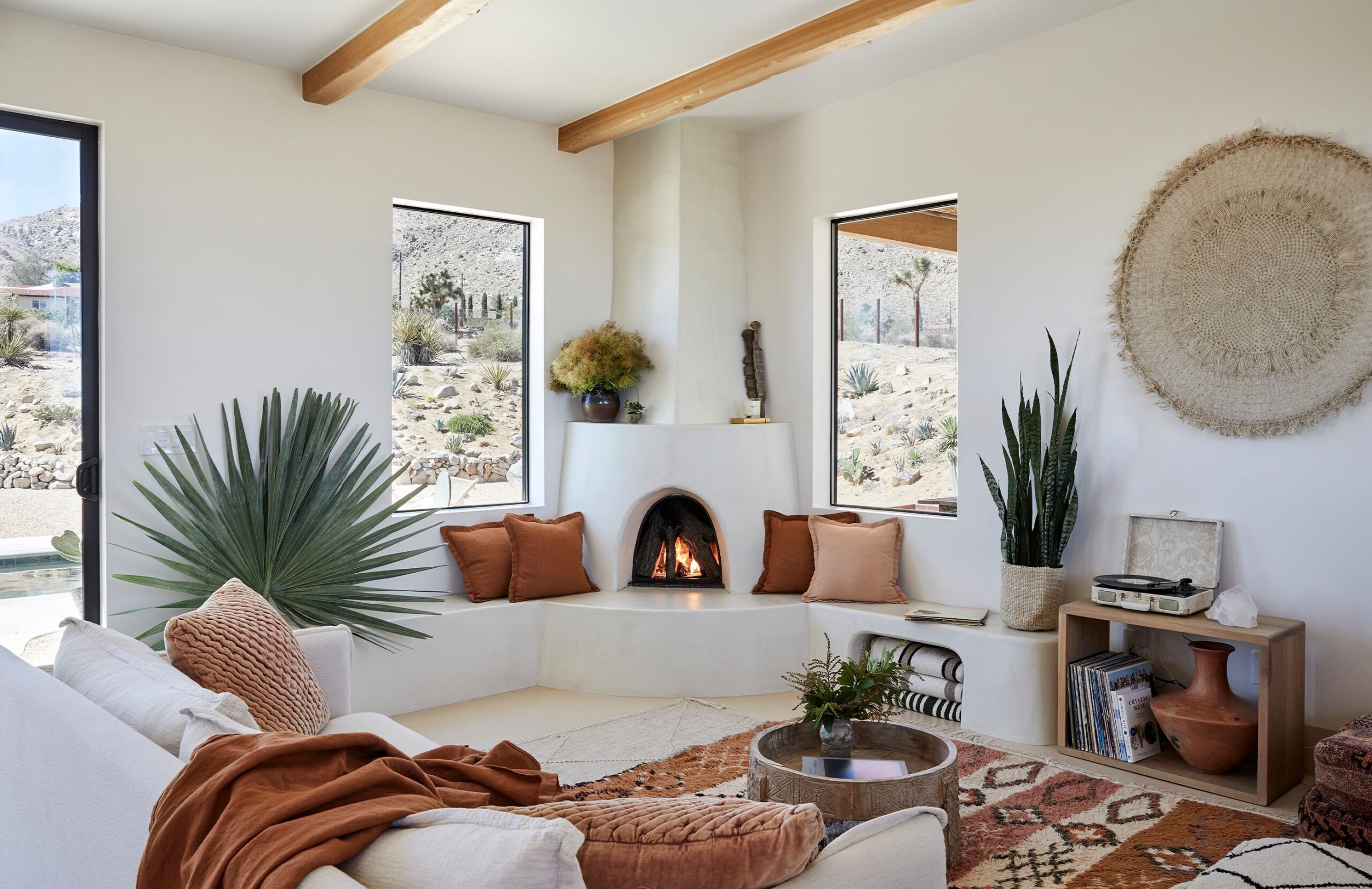 Desert modern decor living room with neutral furniture, plants, natural textures, and earthy interior accents