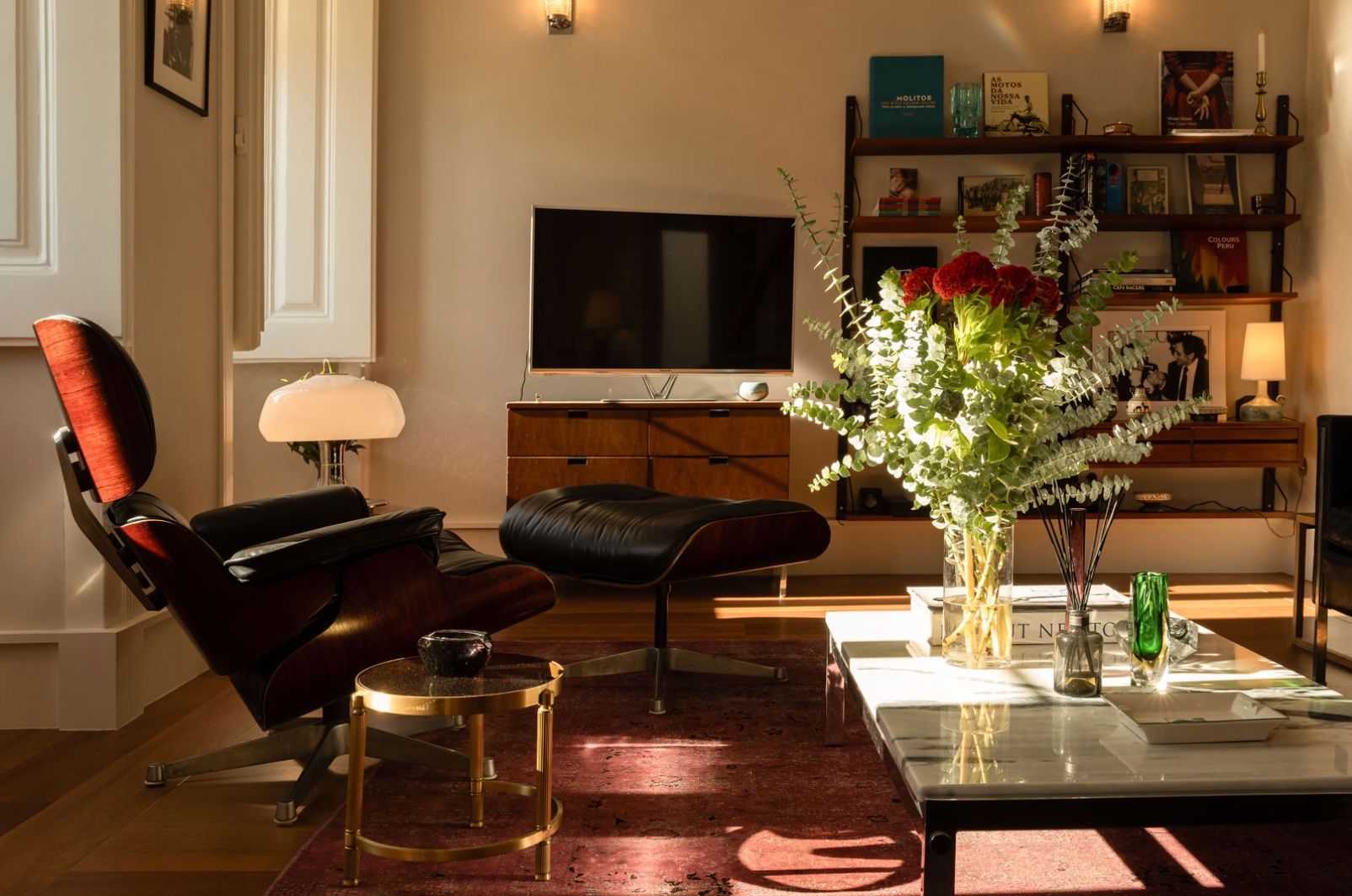 Classic vintage apartment interior with leather chair, fireplace, and elegant traditional decor