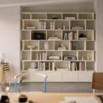 Modern apartment wall storage with built-in shelving and minimalist decor for maximizing small living spaces.