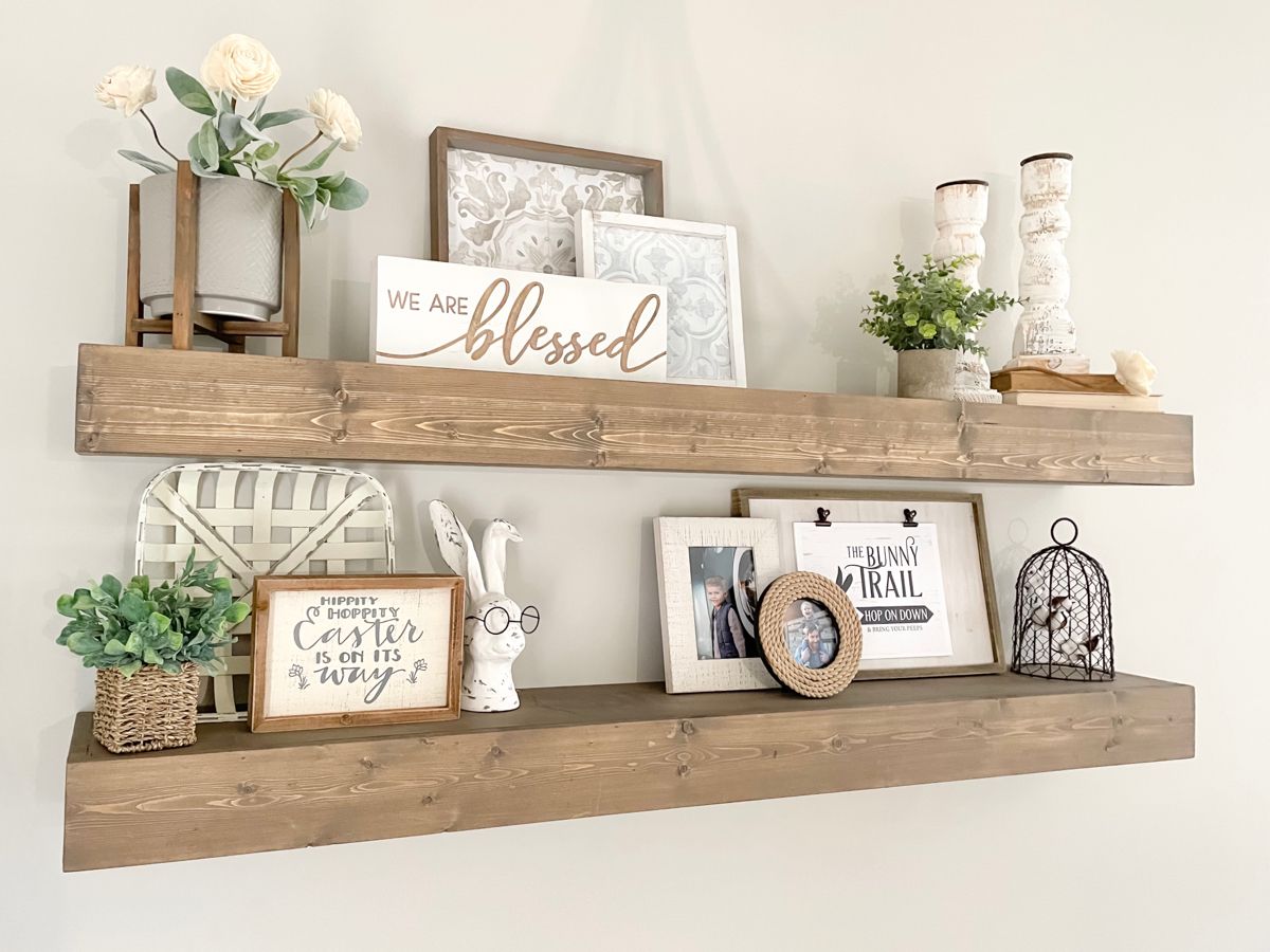 Floating shelf decor with plants, framed artwork, and cozy minimalist wall styling