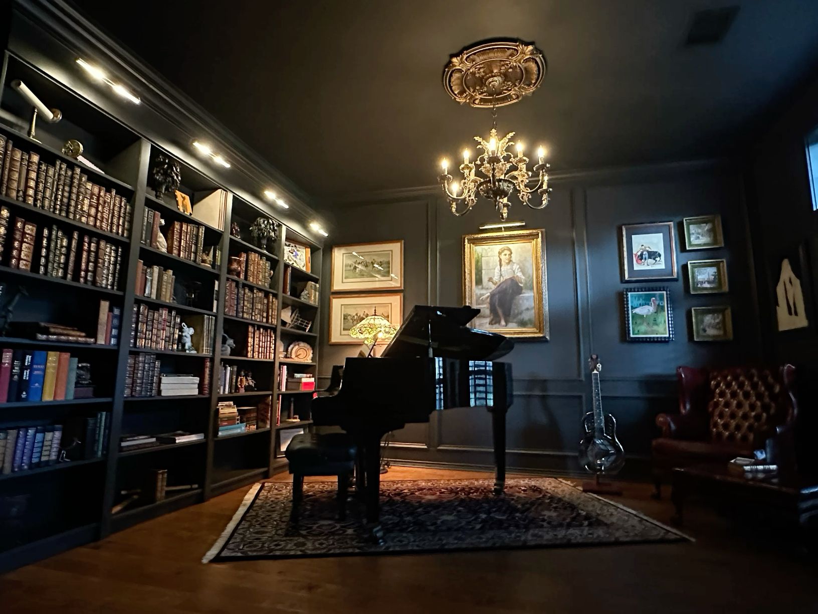 Dark academia home library with grand bookshelves, piano, and moody vintage interior design