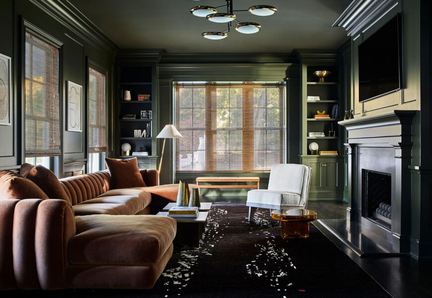 Dark green moody living room with fireplace, classic furniture, and cozy atmospheric lighting