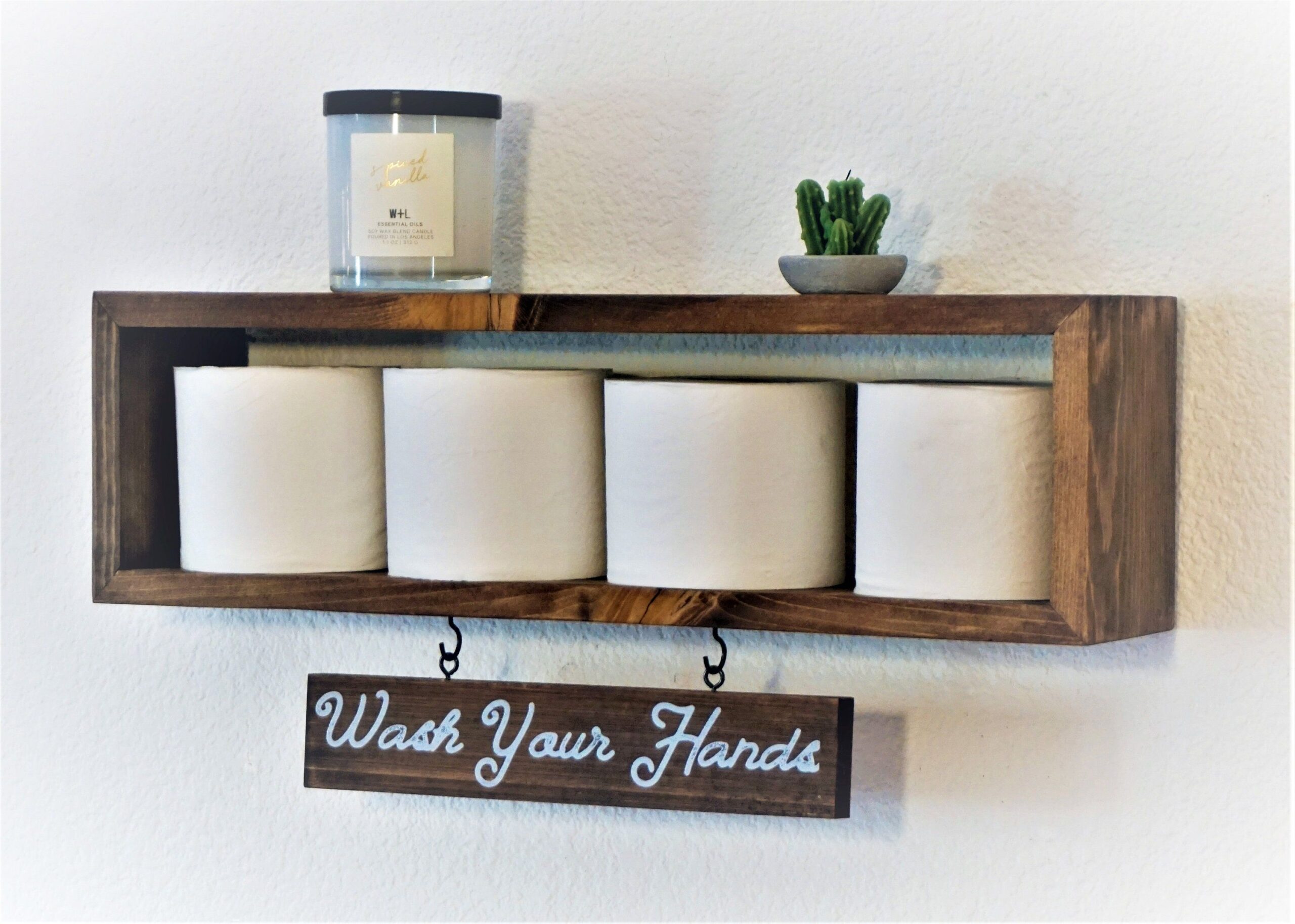 Bathroom floating shelf decor with storage baskets, plants, and minimalist accessories