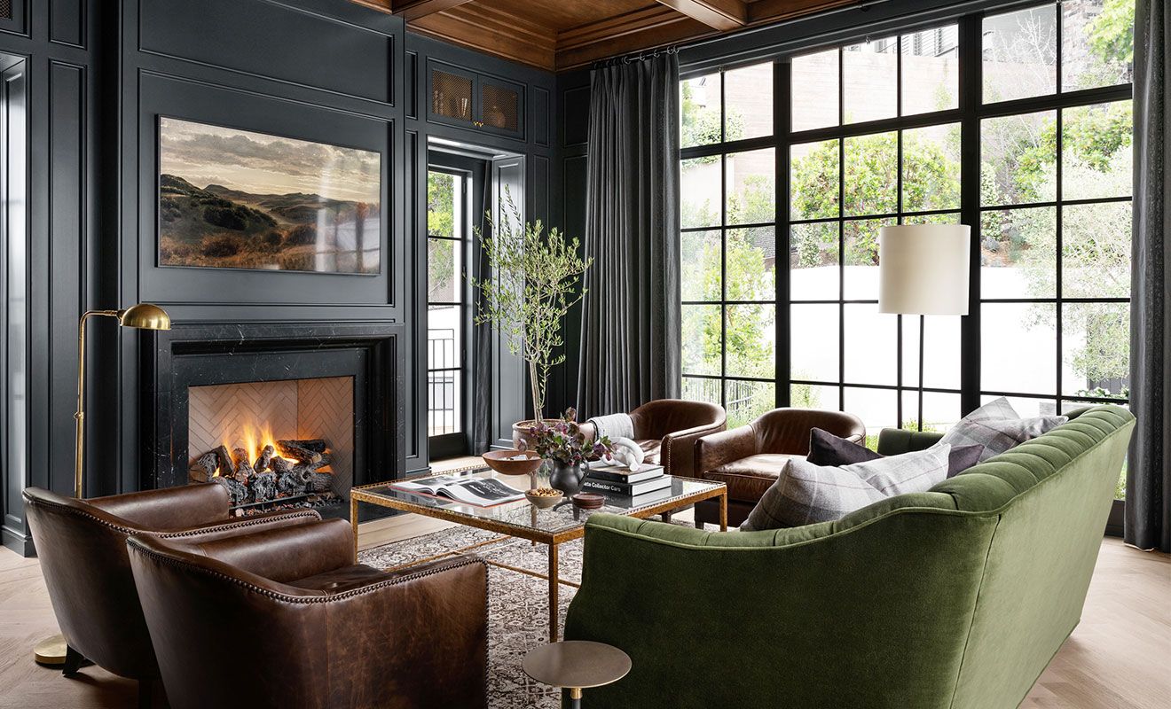 Luxury moody living room with green sofa, dark walls, and elegant contemporary decor