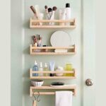 Small bathroom shelves beside door with toiletries, baskets, and space-saving storage