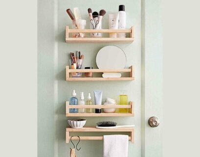 Small bathroom shelves beside door with toiletries, baskets, and space-saving storage